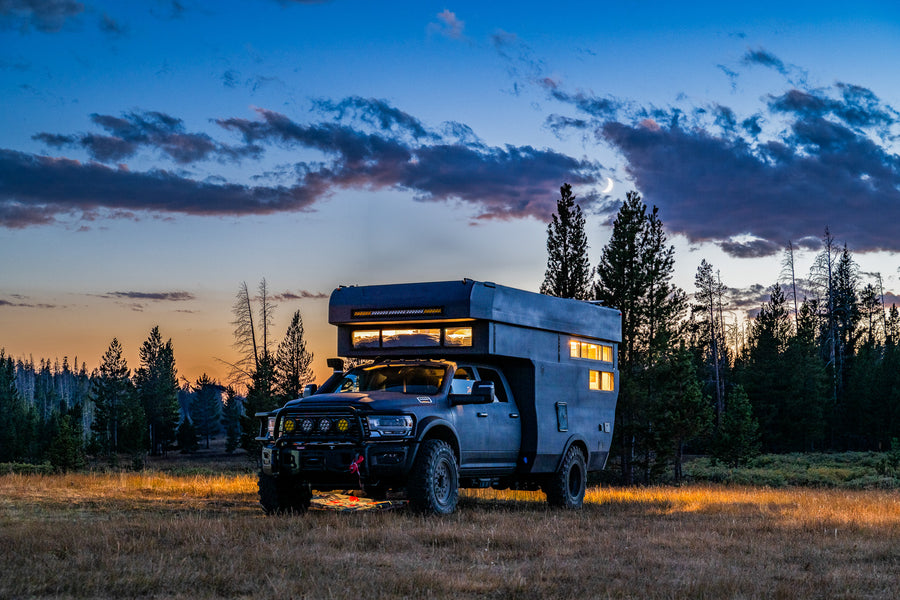 A Rossmonster truck camper at sunset