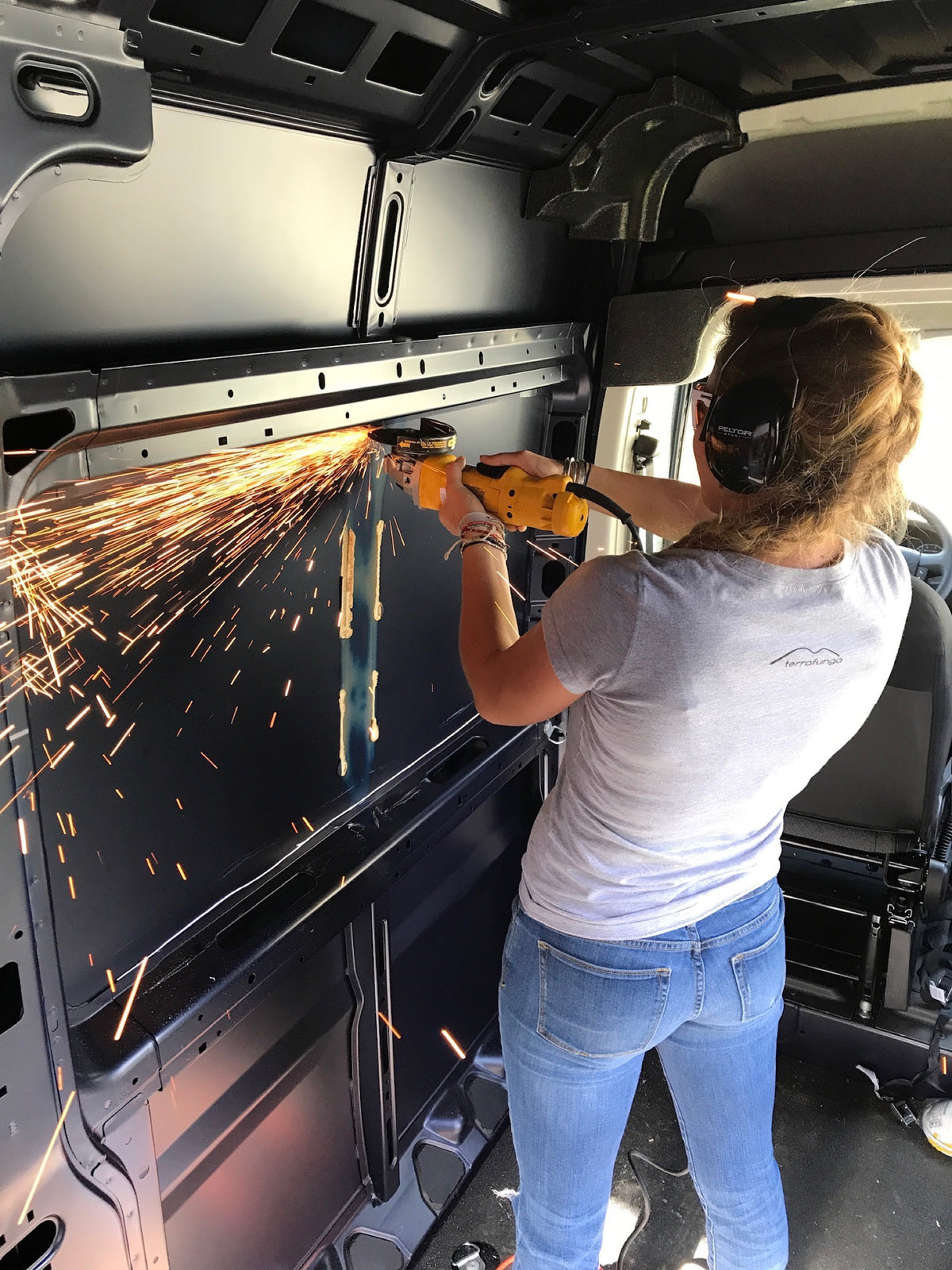Caroline cutting a window opening in the van