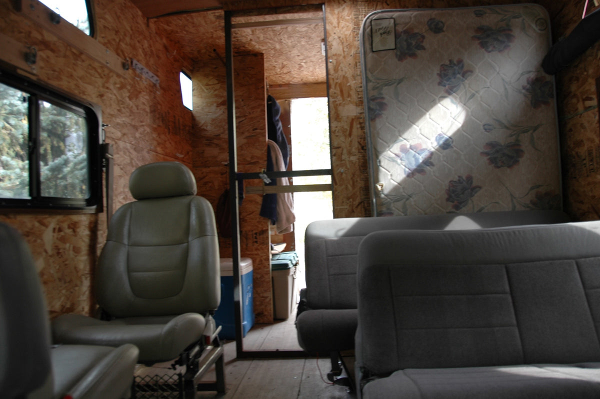 Inside — scrapyard seats and a mattress