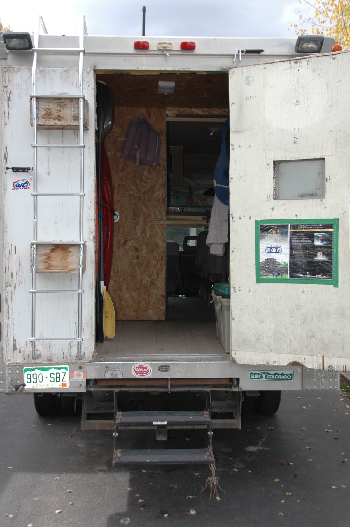The back — twelve kayaks and the paddles