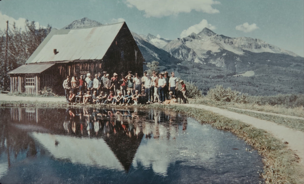 A school group by the pond in front of the barn at Skyline Ranch