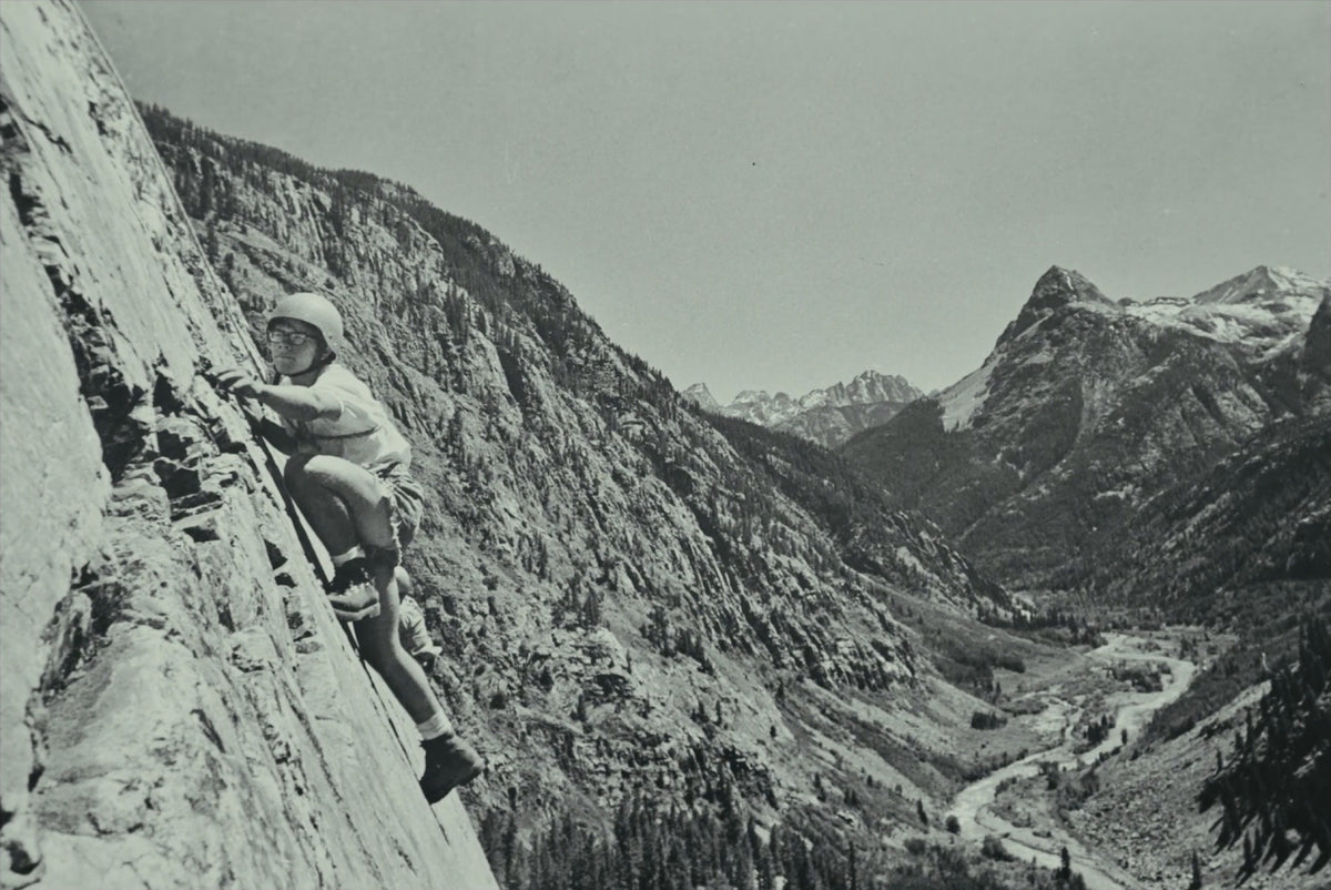 A student leading a slab high above the valley